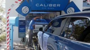 Caliber Carwash Team member washing car